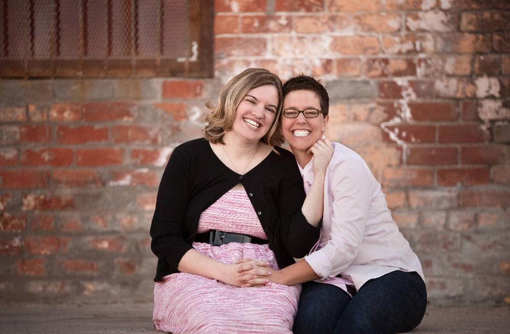 female couple smiling and hugging 