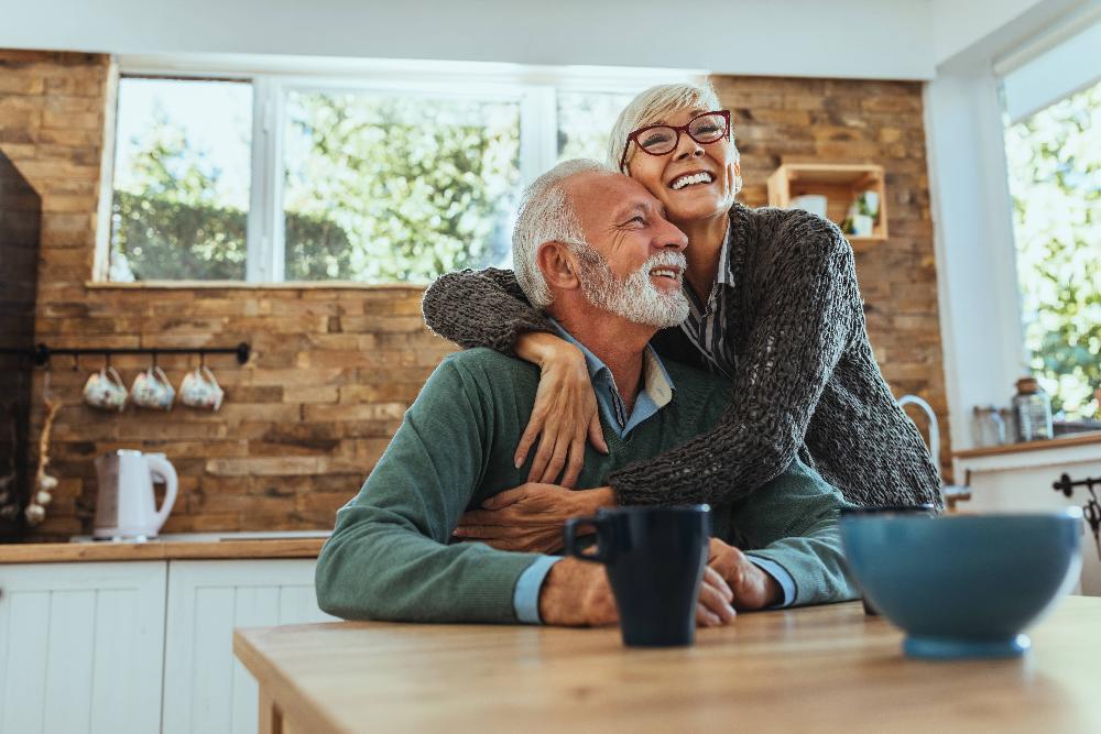 Older man and woman sitting at kitchen table