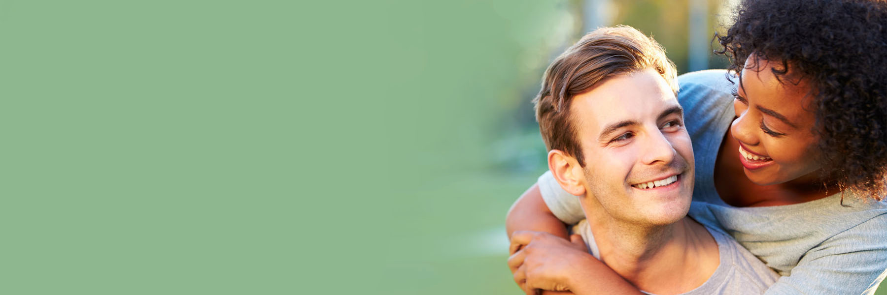 woman hugging her male partner's shoulders 