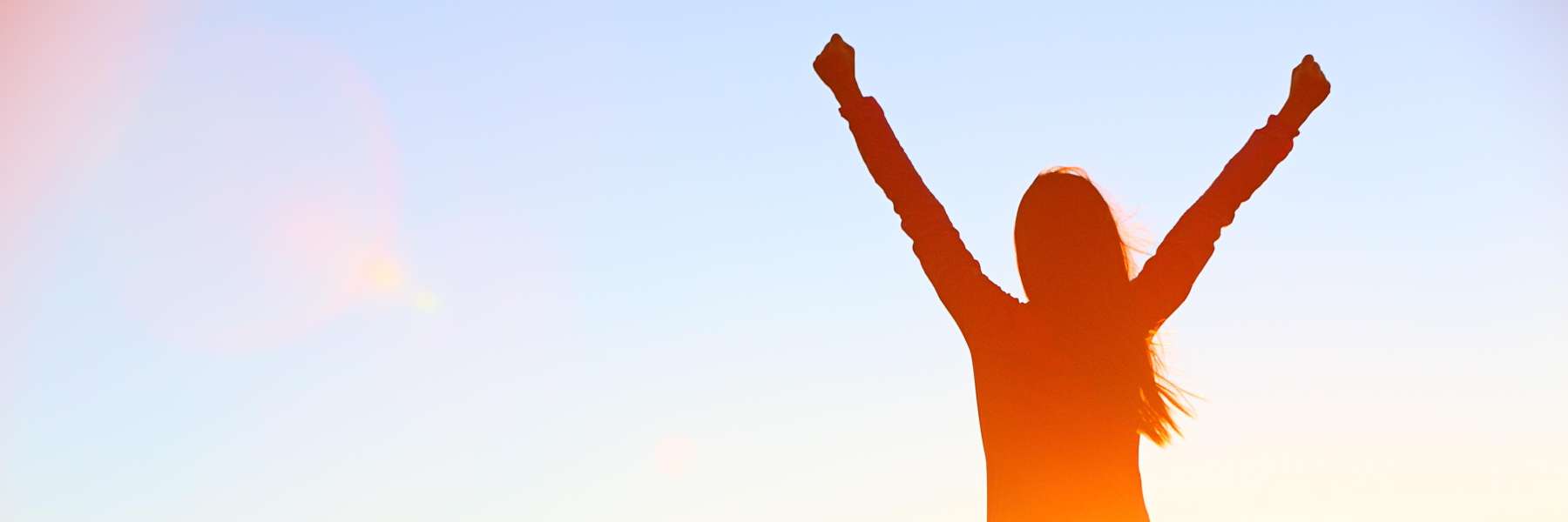 silhouette of woman with her arms up in the air