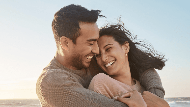 man and woman hugging and smiling