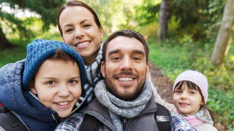 family of four smiling