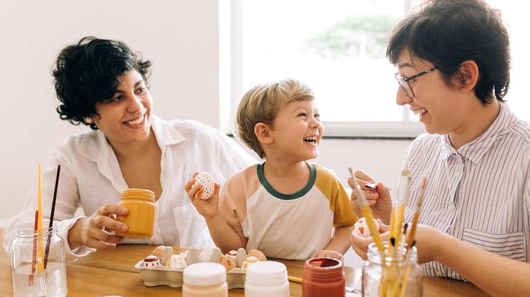 two mothers doing crafts with their young son in washinigton 