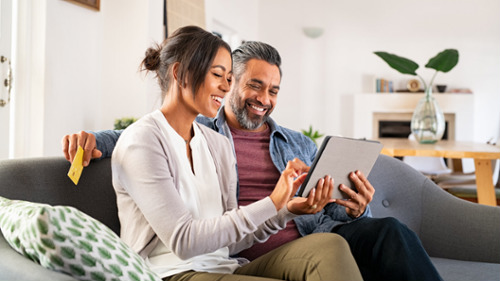 tacoma man and woman smiling while working on tablet